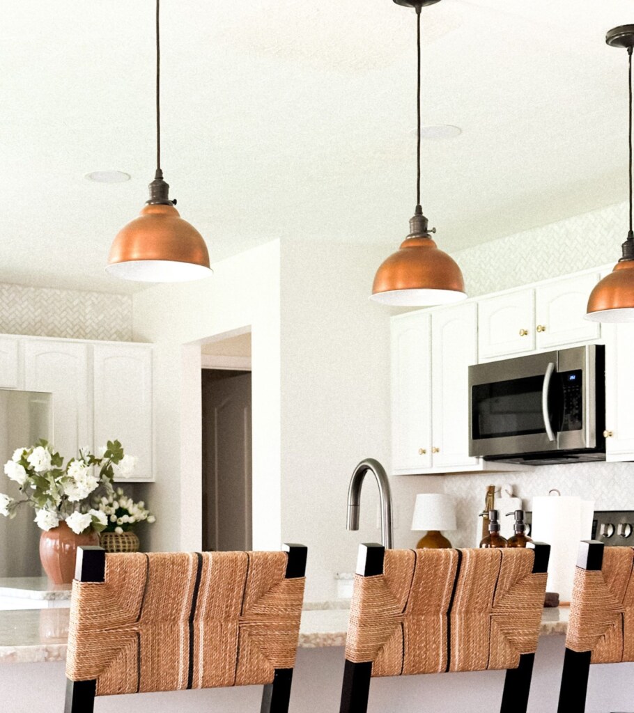 copper lighting in white kitchen